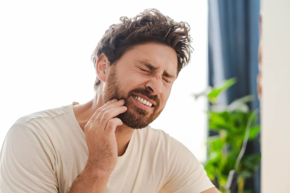 Man has toothache and is in pain